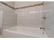Clean white tub and shower with stylish tile and chrome fixtures at 947 Rebel Forest Dr, Atlanta, GA 30315