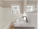 All white bathroom with updated shower-tub combo, toilet and vanity with a granite countertop at 1796 Arkose Se Dr, Atlanta, GA 30316