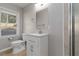Modern bathroom with new fixtures, vanity, toilet, and shower featuring gray walls and tile at 1796 Arkose Se Dr, Atlanta, GA 30316