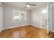 Bright bedroom with hardwood floors, neutral gray walls, a ceiling fan, and an ensuite bathroom at 1796 Arkose Se Dr, Atlanta, GA 30316