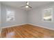 Bedroom with wooden floors, windows and a ceiling fan, perfect for relaxation and comfort at 1796 Arkose Se Dr, Atlanta, GA 30316