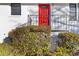 Close-up of a red front door with decorative details, steps, and wrought iron railing at 1796 Arkose Se Dr, Atlanta, GA 30316