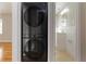 Laundry area with a stackable black washer and dryer situated near a newly renovated bathroom at 1796 Arkose Se Dr, Atlanta, GA 30316
