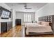 Spacious bedroom featuring hardwood floors, a ceiling fan, and large window at 4206 Whitby Se Way # 15, Smyrna, GA 30080