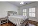 Comfortable bedroom features a bed, side table, and two windows offering natural light at 4206 Whitby Se Way # 15, Smyrna, GA 30080