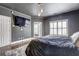 This spacious bedroom features a television, a luxurious bed, wood floors, and a window that brings in natural light at 4206 Whitby Se Way # 15, Smyrna, GA 30080
