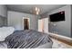 This spacious bedroom features a television, a luxurious bed, wood floors, and a window that brings in natural light at 4206 Whitby Se Way # 15, Smyrna, GA 30080