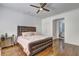 Light bedroom showcasing hardwood floors, white walls, and an ensuite bathroom entrance at 4206 Whitby Se Way # 15, Smyrna, GA 30080