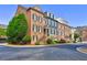 Charming brick townhomes featuring individual entryways and manicured landscaping creating a welcoming curb appeal at 4206 Whitby Se Way # 15, Smyrna, GA 30080