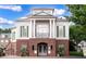 Beautiful brick and wood facade with white pillars and upper balcony entrance, creating a stately home exterior at 4206 Whitby Se Way # 15, Smyrna, GA 30080
