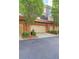 Exterior view of a garage and driveway, surrounded by manicured bushes and trees at 4206 Whitby Se Way # 15, Smyrna, GA 30080