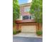 Exterior view of a garage and driveway with trees and bushes around at 4206 Whitby Se Way # 15, Smyrna, GA 30080