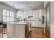 Bright white kitchen featuring an island with marble countertops, stainless steel appliances, and hardwood floors at 4206 Whitby Se Way # 15, Smyrna, GA 30080