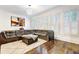 Spacious living room with hardwood floors, large windows with shutter-style blinds, and a comfortable leather sectional at 4206 Whitby Se Way # 15, Smyrna, GA 30080