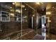 Spacious main bathroom featuring walk-in shower with glass door and dark tile at 4206 Whitby Se Way # 15, Smyrna, GA 30080