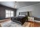 Spacious main bedroom with dark walls, hardwood floors, area rug, and large windows at 4206 Whitby Se Way # 15, Smyrna, GA 30080