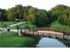 Picturesque park scene with a bridge crossing a tranquil river, framed by lush greenery at 4206 Whitby Se Way # 15, Smyrna, GA 30080
