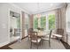 Bright dining area with natural light, shutters, and views into sunroom at 4538 Collins Ave, Sandy Springs, GA 30342