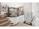 Bright foyer featuring elegant staircase with carpeted steps, wood railing, and views to the living room at 4538 Collins Ave, Sandy Springs, GA 30342