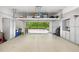 Spacious garage with epoxy floors, overhead storage, and built-in white cabinets at 4538 Collins Ave, Sandy Springs, GA 30342