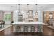 Modern kitchen featuring a large island, stainless steel appliances, and beautiful pendant lighting at 4538 Collins Ave, Sandy Springs, GA 30342
