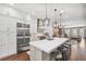 Bright, open kitchen with large island, stainless steel appliances, and seamless flow to dining and living areas at 4538 Collins Ave, Sandy Springs, GA 30342