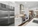 Kitchen with stainless steel refrigerator and gas range and beautiful lighting at 4538 Collins Ave, Sandy Springs, GA 30342