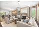 Open-concept living room with fireplace, dark floors, and seamless access to the dining and kitchen areas at 4538 Collins Ave, Sandy Springs, GA 30342