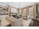Inviting living room boasts stone fireplace, large windows, dark floors, and neutral color palette at 4538 Collins Ave, Sandy Springs, GA 30342