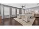 Spacious main bedroom with hardwood floors, plush seating, and large windows with plantation shutters at 4538 Collins Ave, Sandy Springs, GA 30342
