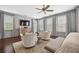 Inviting main bedroom has hardwood floors, a seating area, and abundant natural light at 4538 Collins Ave, Sandy Springs, GA 30342