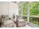 Cozy screened porch features comfortable seating and a peaceful view of the lush greenery at 4538 Collins Ave, Sandy Springs, GA 30342