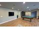 Basement with a pool table, bar, and TV area, creating an ideal space for entertaining at 6355 Westfallen Overlook, Cumming, GA 30040