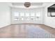 Bright bedroom with hardwood floors and a bay window offering scenic neighborhood views at 6355 Westfallen Overlook, Cumming, GA 30040