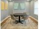 Dining area featuring a round table with seating for four, artwork, and carpet for a cozy space at 6355 Westfallen Overlook, Cumming, GA 30040
