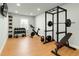 Equipped gym with weight racks, kettlebells, exercise bike and tv for a complete fitness experience at 6355 Westfallen Overlook, Cumming, GA 30040
