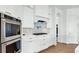 Modern white kitchen featuring stainless steel appliances, gas range, and white cabinetry at 6355 Westfallen Overlook, Cumming, GA 30040