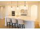 Bright, modern kitchen with white cabinets, stainless appliances, an island and pendant lighting at 6355 Westfallen Overlook, Cumming, GA 30040