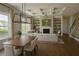 Open living space with dining table, fireplace, large windows and a cozy seating area with natural light at 6355 Westfallen Overlook, Cumming, GA 30040