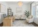 Bright office space with a wooden desk, comfortable seating, and a large window for natural light at 6355 Westfallen Overlook, Cumming, GA 30040