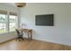 Bright office space features a desk with a view, a TV on the wall, and ample natural light at 6355 Westfallen Overlook, Cumming, GA 30040