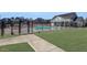 Neighborhood pool surrounded by a fence and lush green grass in the community at 6355 Westfallen Overlook, Cumming, GA 30040