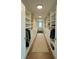 Bright walk-in closet featuring custom shelving, drawers, and a cozy bench by the window at 6355 Westfallen Overlook, Cumming, GA 30040
