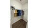 Organized walk-in closet with hanging racks, shelving, and a chest of drawers for optimal storage at 6355 Westfallen Overlook, Cumming, GA 30040