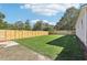 A wide backyard featuring new fencing and lush green grass at 7540 Conyers St, Lithonia, GA 30058