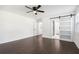 Bedroom with dark hardwood floors and sliding barn door that opens to the bathroom at 7540 Conyers St, Lithonia, GA 30058