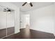 Bedroom boasts mirrored closet doors, ceiling fan, and access to connecting rooms at 7540 Conyers St, Lithonia, GA 30058