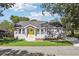 Charming single-story home with yellow front door and well-manicured lawn at 7540 Conyers St, Lithonia, GA 30058