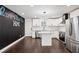 Modern kitchen with stainless steel appliances, white cabinets, and dark chalkboard wall at 7540 Conyers St, Lithonia, GA 30058