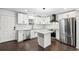 Bright kitchen with stainless steel appliances, white cabinetry, and a center island at 7540 Conyers St, Lithonia, GA 30058